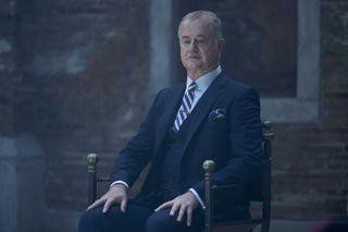 Owen Teale as leader of the witches Peter Knox.