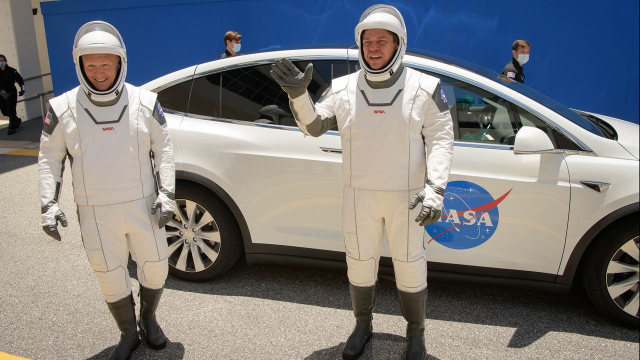 NASA astronauts Bob Behnken and Doug Hurley walk out of NASA's Astronaut Crew Quarters and take a Tesla Model X to Launch Pad 39A during a dry-run test of their SpaceX Crew Dragon Demo-2 flight on May 23, 2020 at the Kennedy Space Center in Florida.