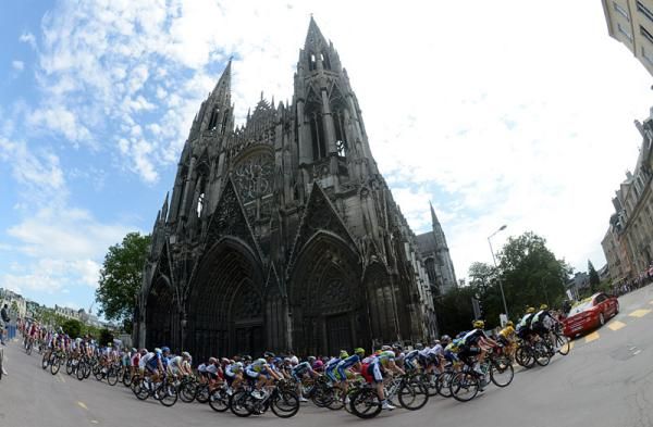 The peloton rolls through the streets of Rouen during the neutral section at the stage start.