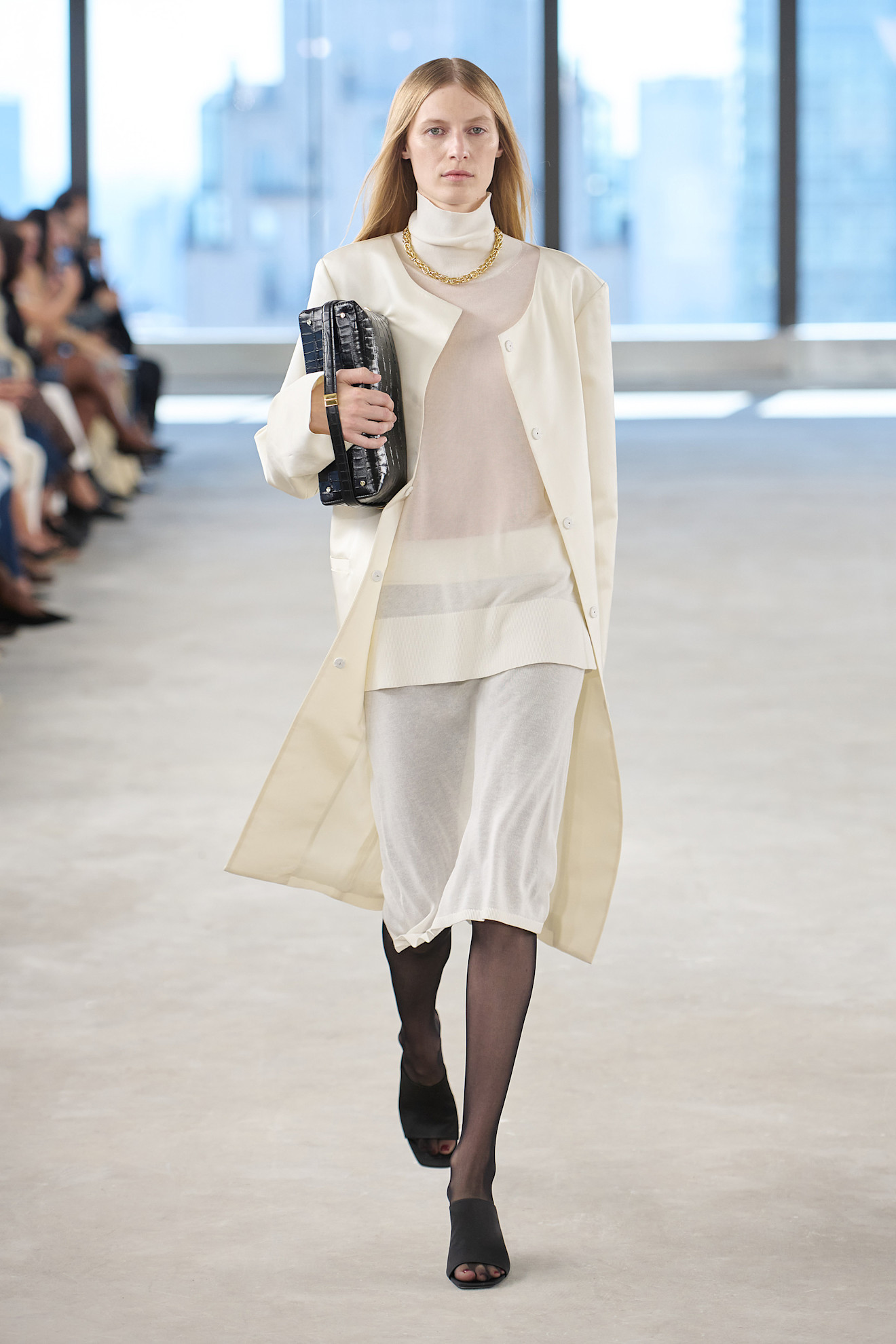 spring 2025 Toteme model wearing a satin coat