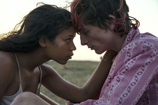 taylor russell and timothee chalamet embracing on a hillside in the movie bones and all