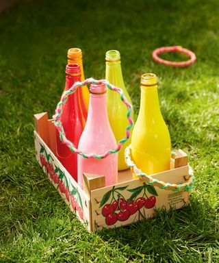 A traditional home made hoopla game with colorful drinks bottles