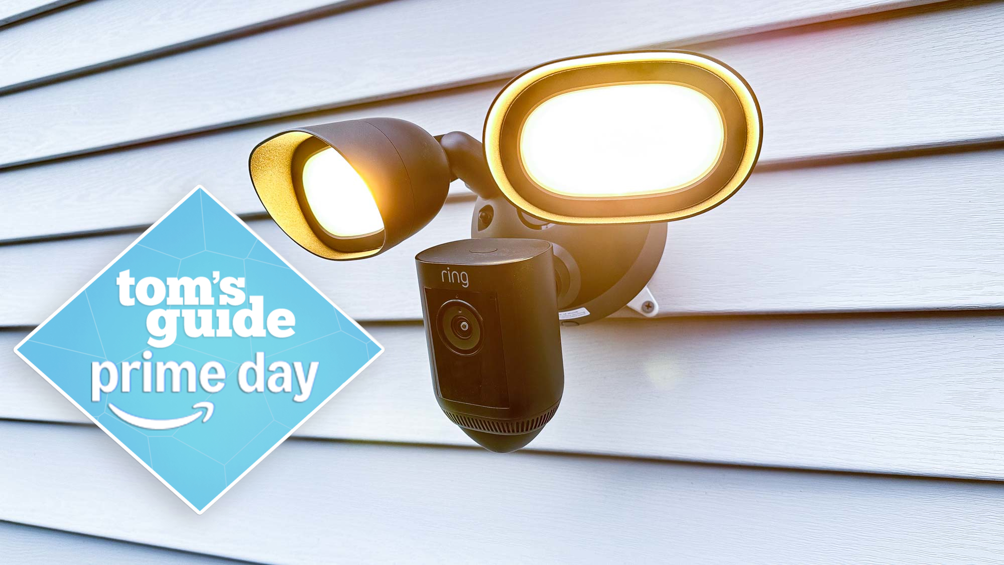 The Ring Floodlight Cam Wired Pro mounted on an exterior wall with a Tom's Guide Prime Day deals badge