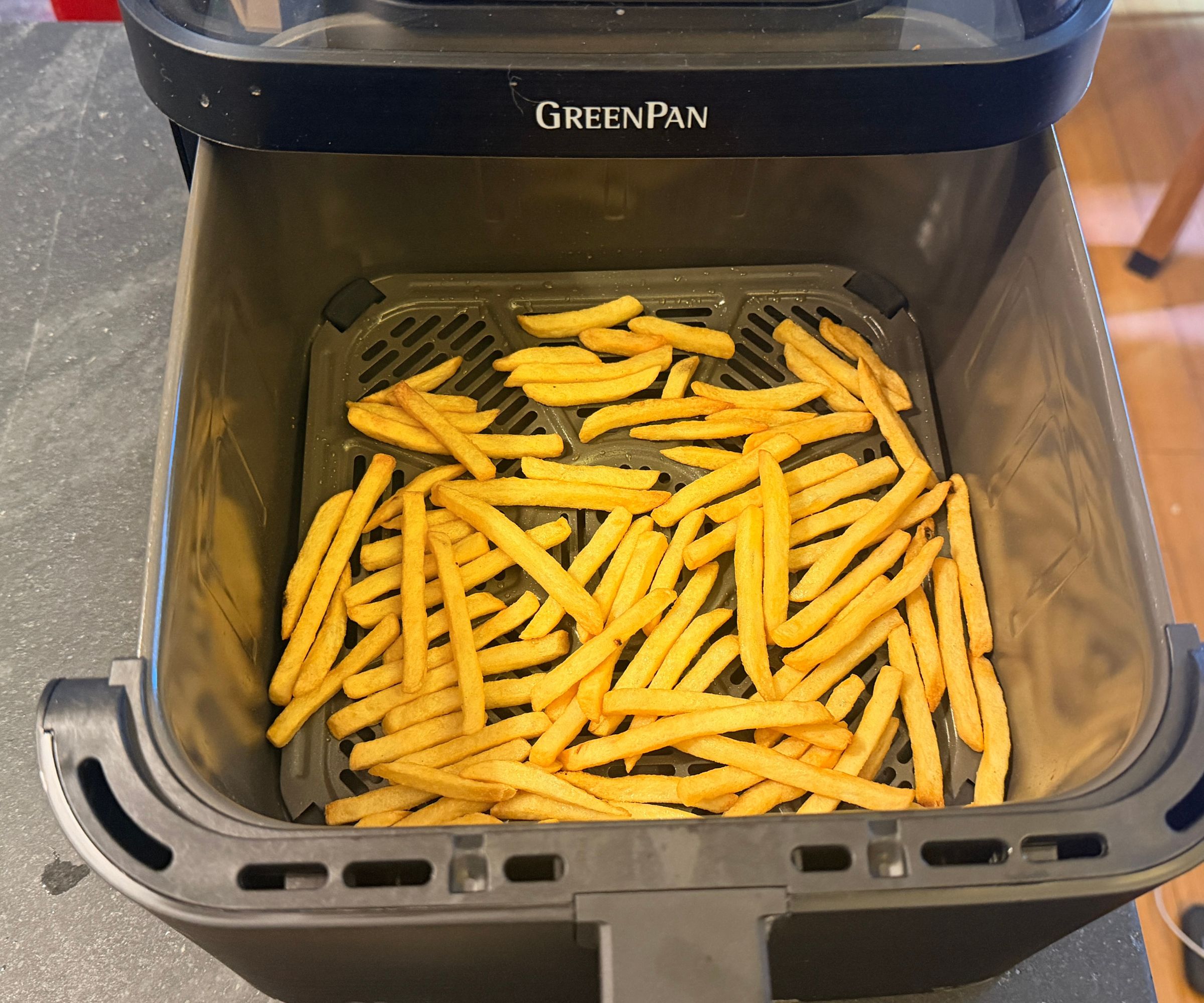 The GreenPan Bistro 360 Air Fryer open on the counter showing cooked fries