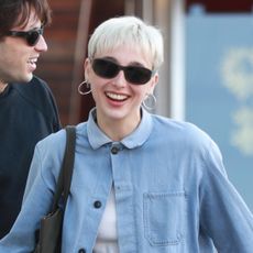 Emma Chamberlain wearing a chambray denim jacket and khaki pants