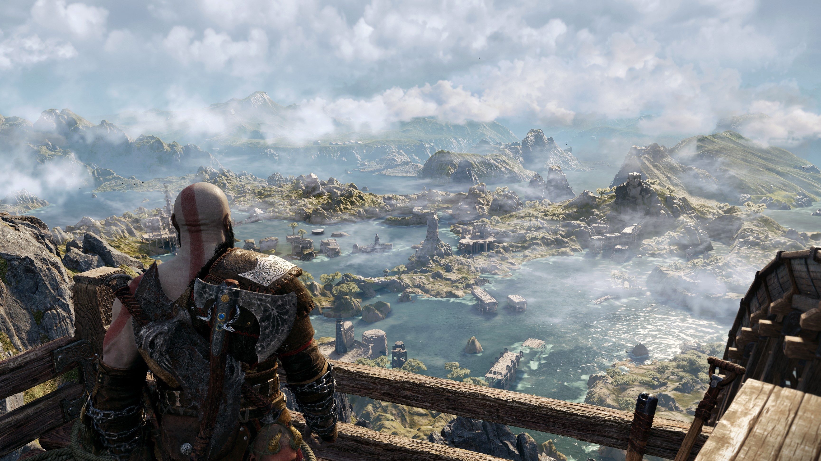 God of war: Ragnarok Kratos looks out over a rocky, cloudy landscape