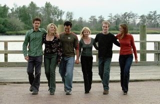 the cast of dawson's creek walks arm in arm on a dock