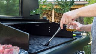 Oiling a grill with brush