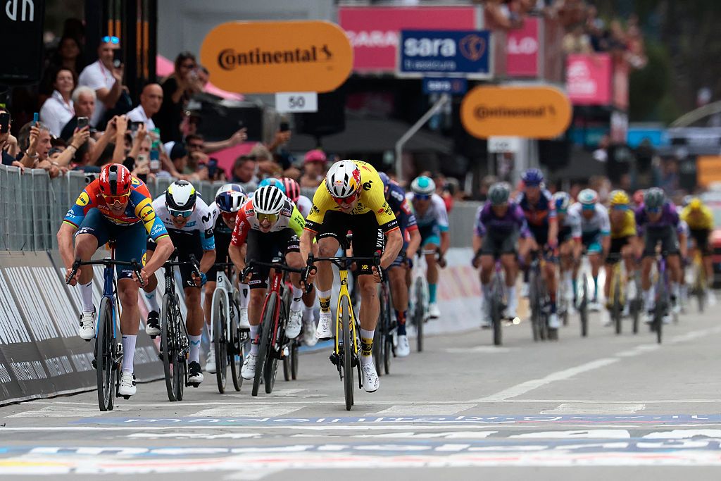 Lidl-Trek's Danish rider Mads Pedersen (L), next to Team Visma-Lease a Bike's Belgian rider Wout Van Aert (R), sprints to win the first stage of the 108th Giro d'Italia cycling race, 160km from Durres to Tirana in Albania, on May 9, 2025. (Photo by Luca Bettini / AFP)