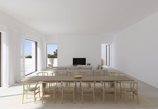 A minimalist style living space with a long dining table