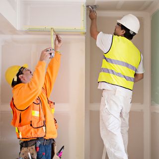 workers working in white room with tape