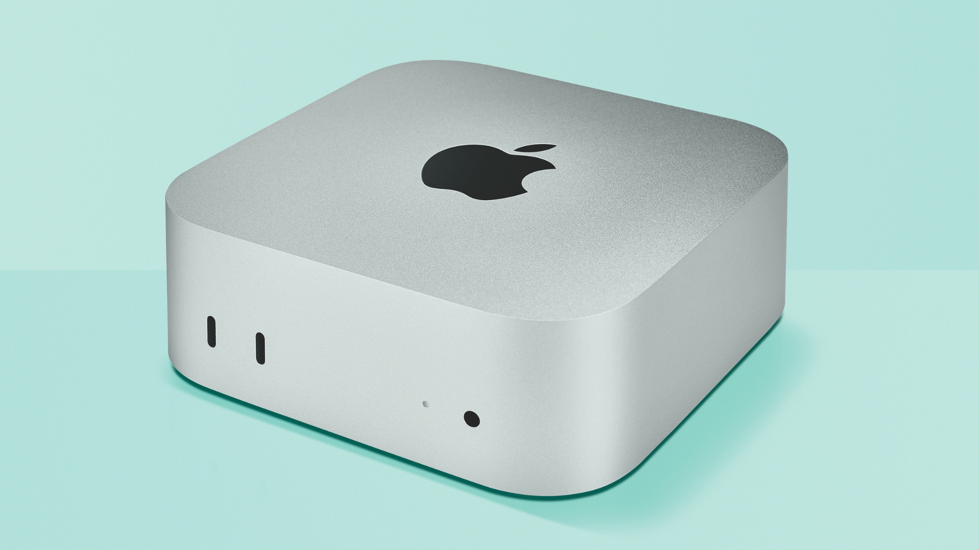 An Apple Mac Mini M4 on a light green background