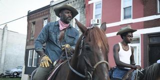 Idris Elba and Caleb McLaughlin on horses in Concrete Cowboy