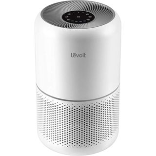 A white cylindrical air purifier with a fan built into the top 