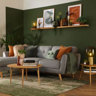 Green wall with lamp and table