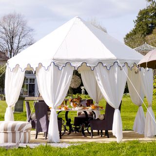 Outdoor with curtains and dinning table with chairs