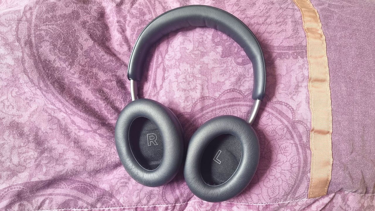 Bose QuietComfort headphones laid out on a purple pillow