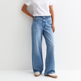 Flat lay image of woman wearing denim jeans 