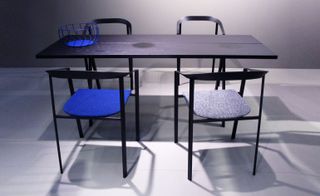 Black table, blue chair and grey chair