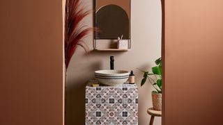 Rust coloured bathroom with mosaic tiles