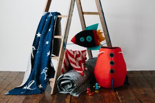 Rocket laundry basket with towels hanging over a ladder