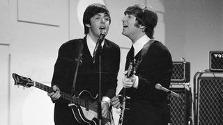Members of the British rock band The Beatles, Paul McCartney (left) and John Lennon (1940 - 1980), sing into a microphone as they play their instruments at the taping of a segment for 'Toast of the Town,' the CBS variety program hosted by Ed Sullivan, New York, August 14, 1965. The segment aired as part of Sullivan's 19th season opener on September 12, 1965. (Photo by CBS Photo Archive/Getty Images)