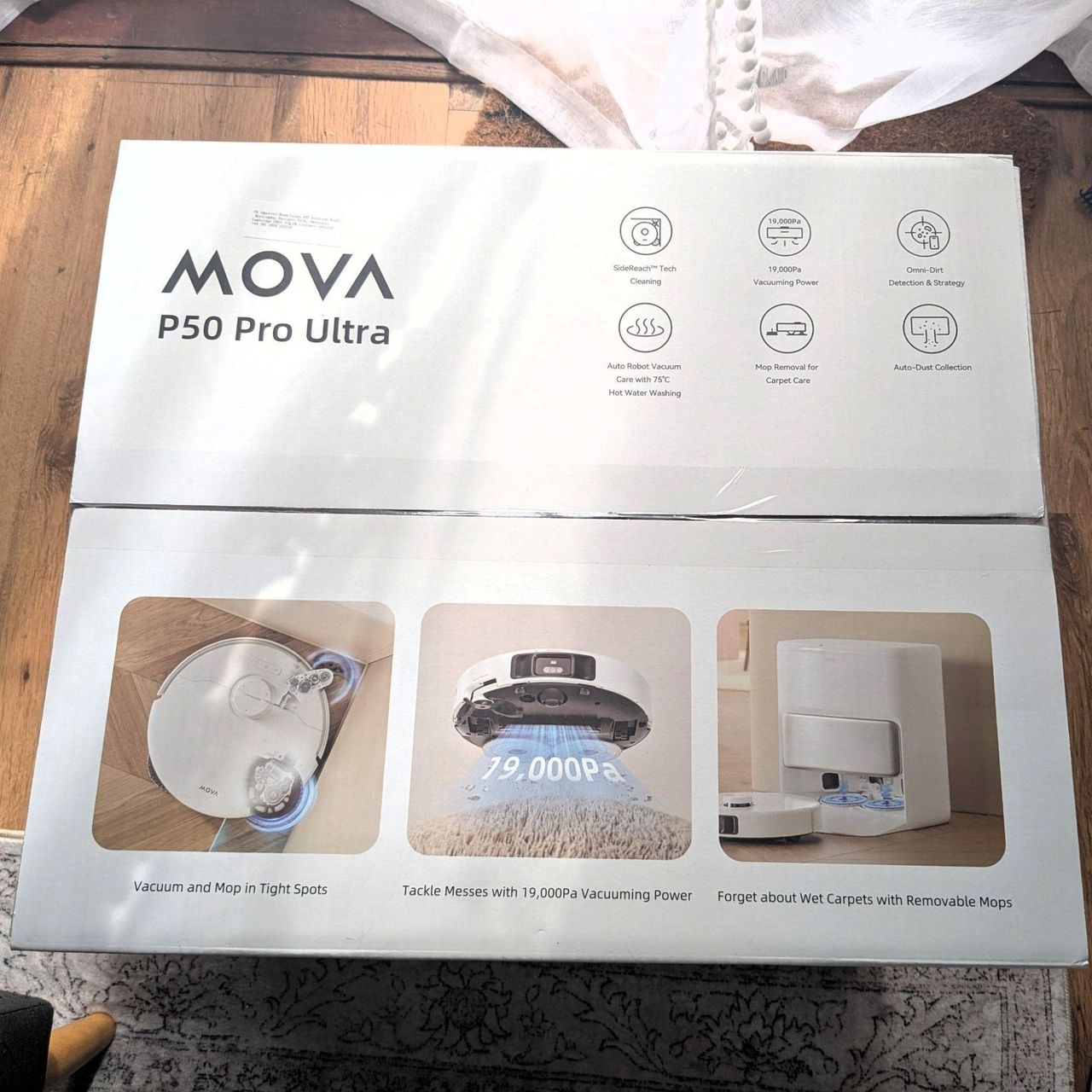 White box of the MOVA P50 Pro Ultra Robot Vacuum sitting on the floor, with pictures of the robot vacuum on it