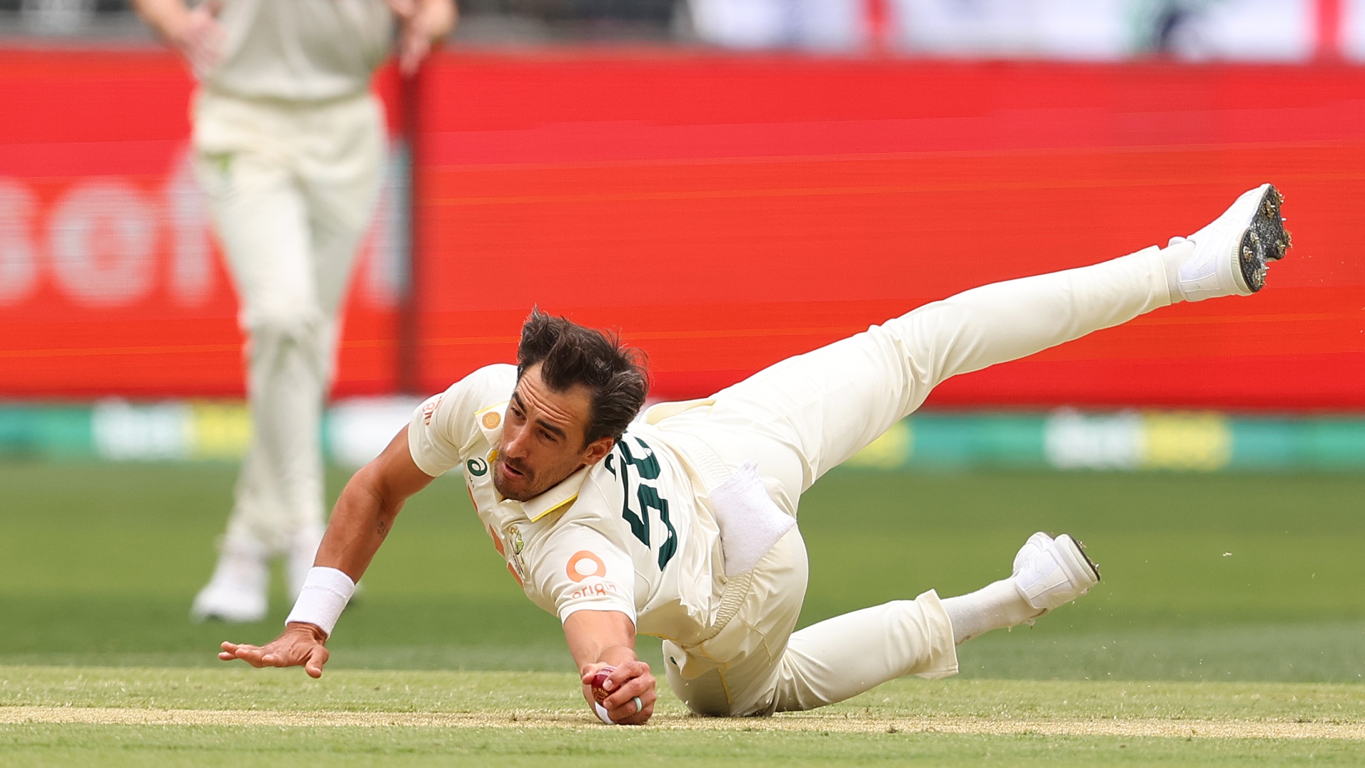Mitchell Starc of Australia diving for a catch to dismiss Zak Crawley of England during the 1st Test of The Ashes 2025/26