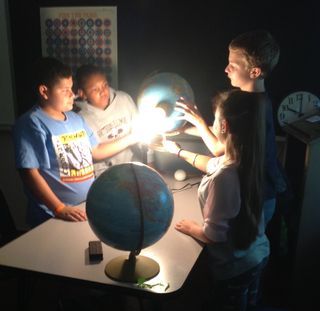 Students use physical models to understand the relationship between the motions and paths of the sun, moon and Earth.