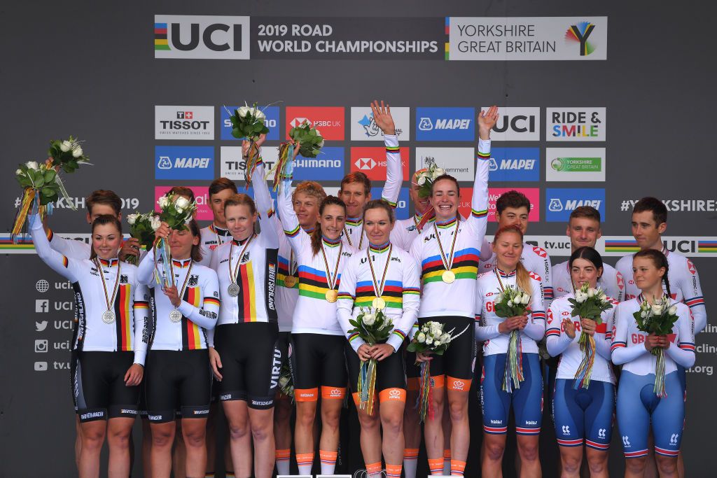 Waves to the crowd from the podium finishers