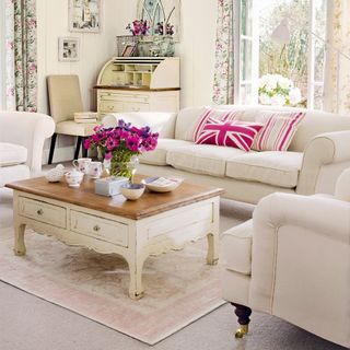 living room with sofa set and floral curtains