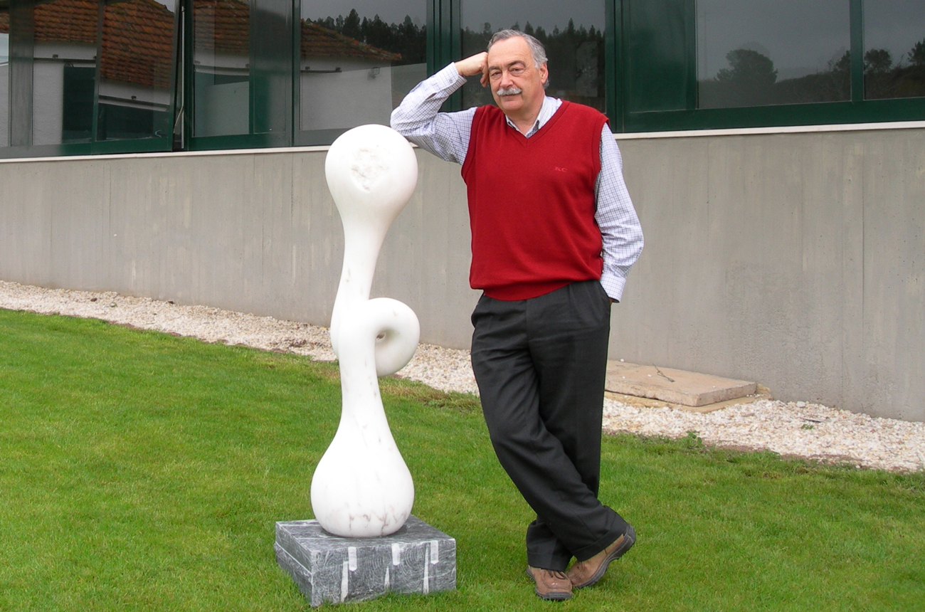 Winemaker Lu&amp;iacute;s Pato leans against a sculpture at his winery