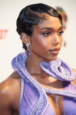 lori harvey with short hair styled in a pixie cut.