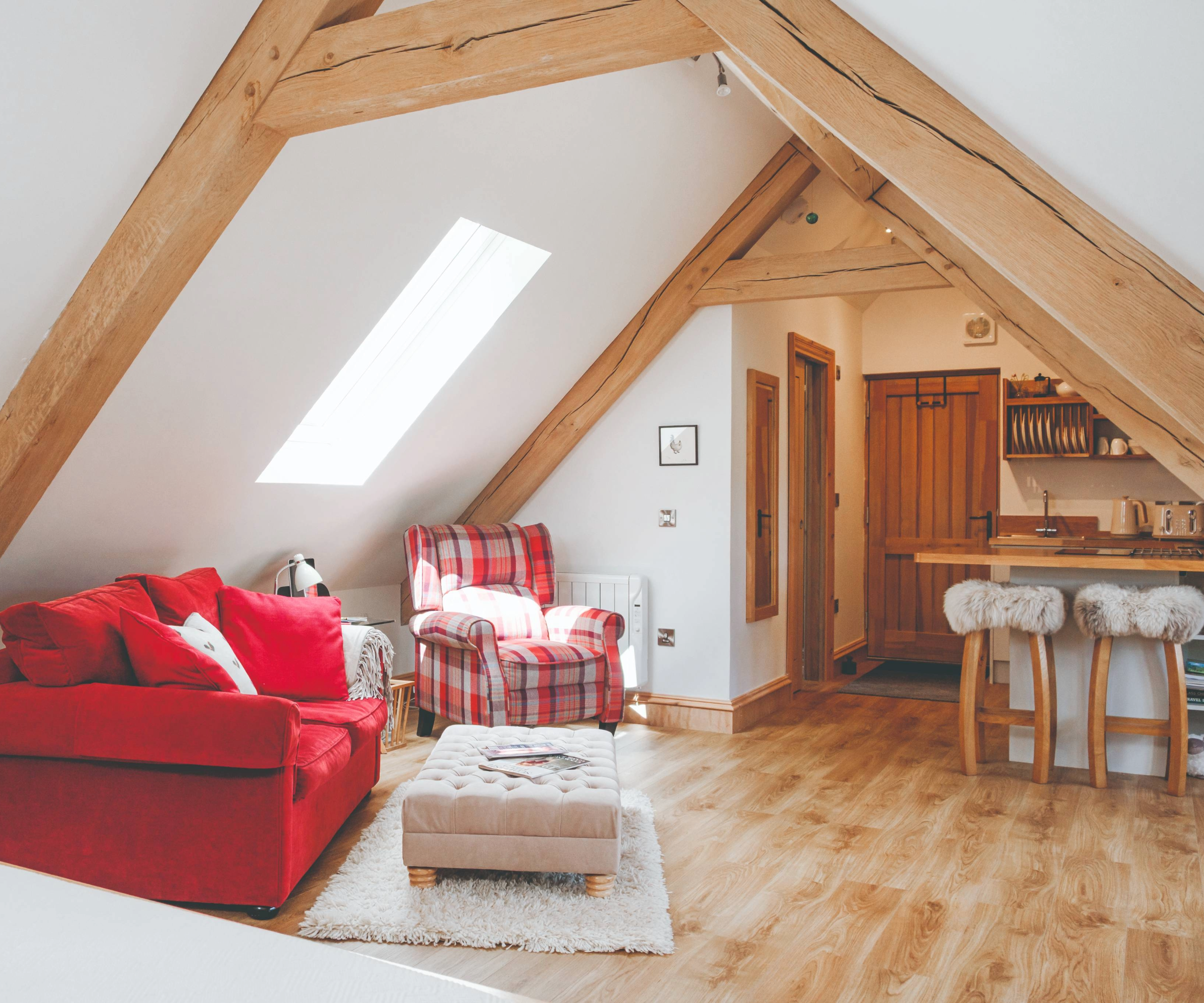 Inside the bedroom above the barn, featuring a mini kitchen and living area