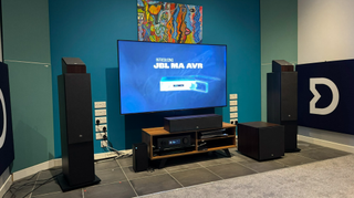 A TV on a media unit with speakers on either side