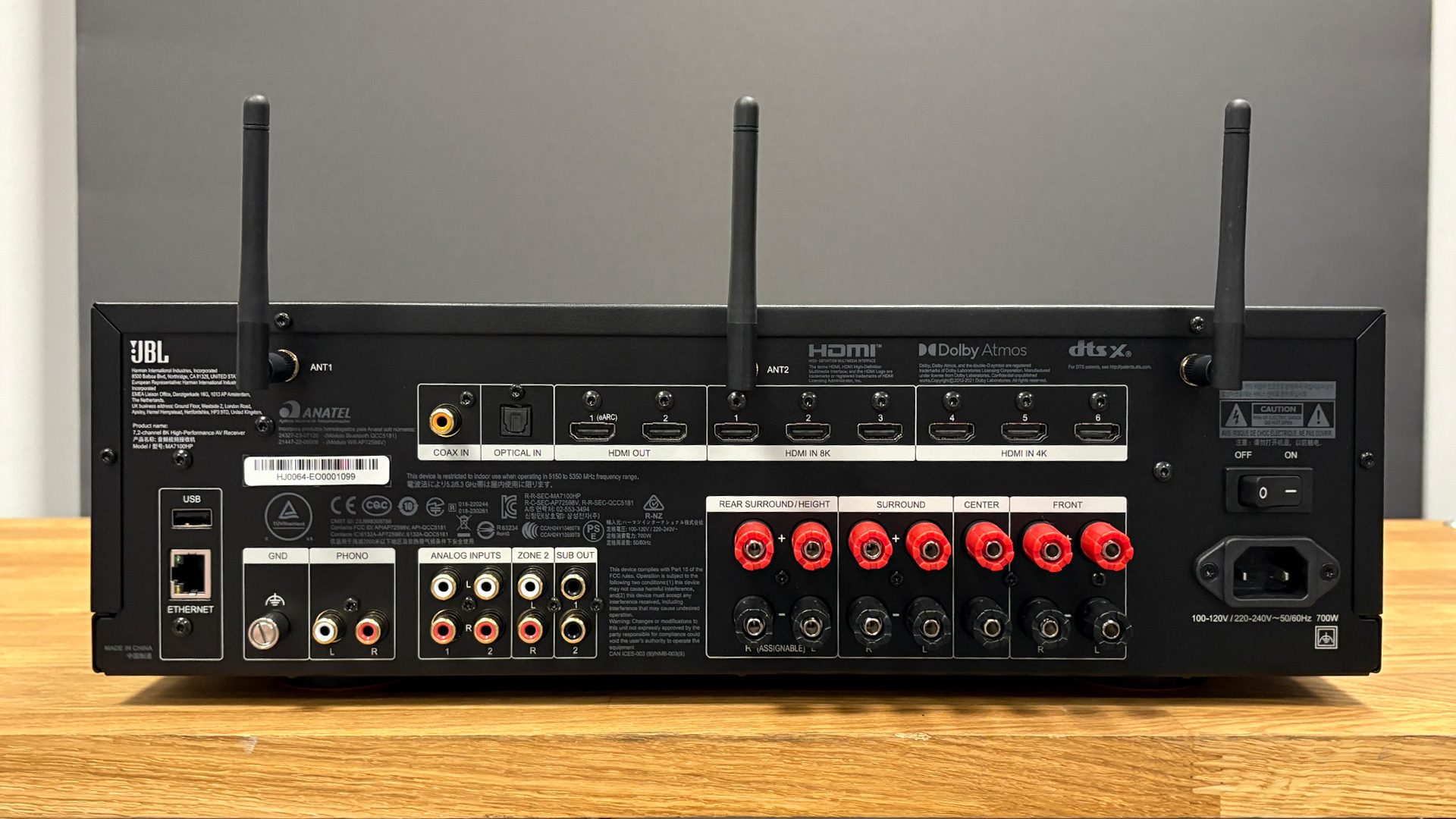 JBL MA7100HP AV receiver on wooden hi-fi rack showing rear connections