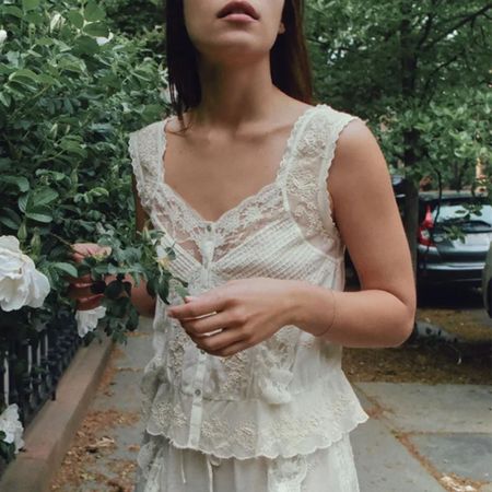 Woman in white embroidered Zara top