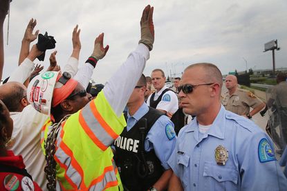 35 arrested in clash at a Ferguson protest