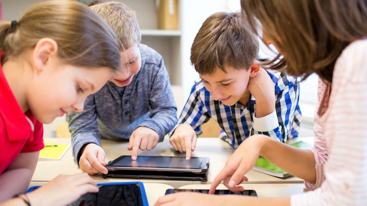 School children using technology in class