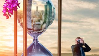 an hourglass with a skyscraper scene in it