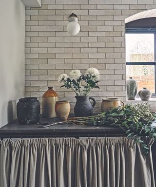 pantry with grey worktop and tiles and unit curtain