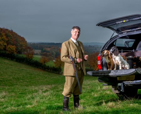 Bringing home the Christmas dinner: Andrew Holloway with his dogs Mo and Carew.