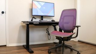 The Steelcase Karman office chair in front of a standing desk