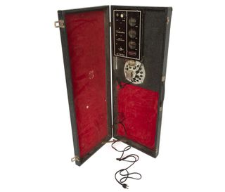 A '60s Silvertone electric guitar (pictured in guitar gallery above) and suitcase amplifier case (est. $1000-1200)