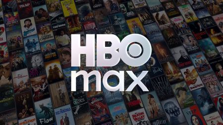 The HBO Max logo in front of a collage of its latest titles