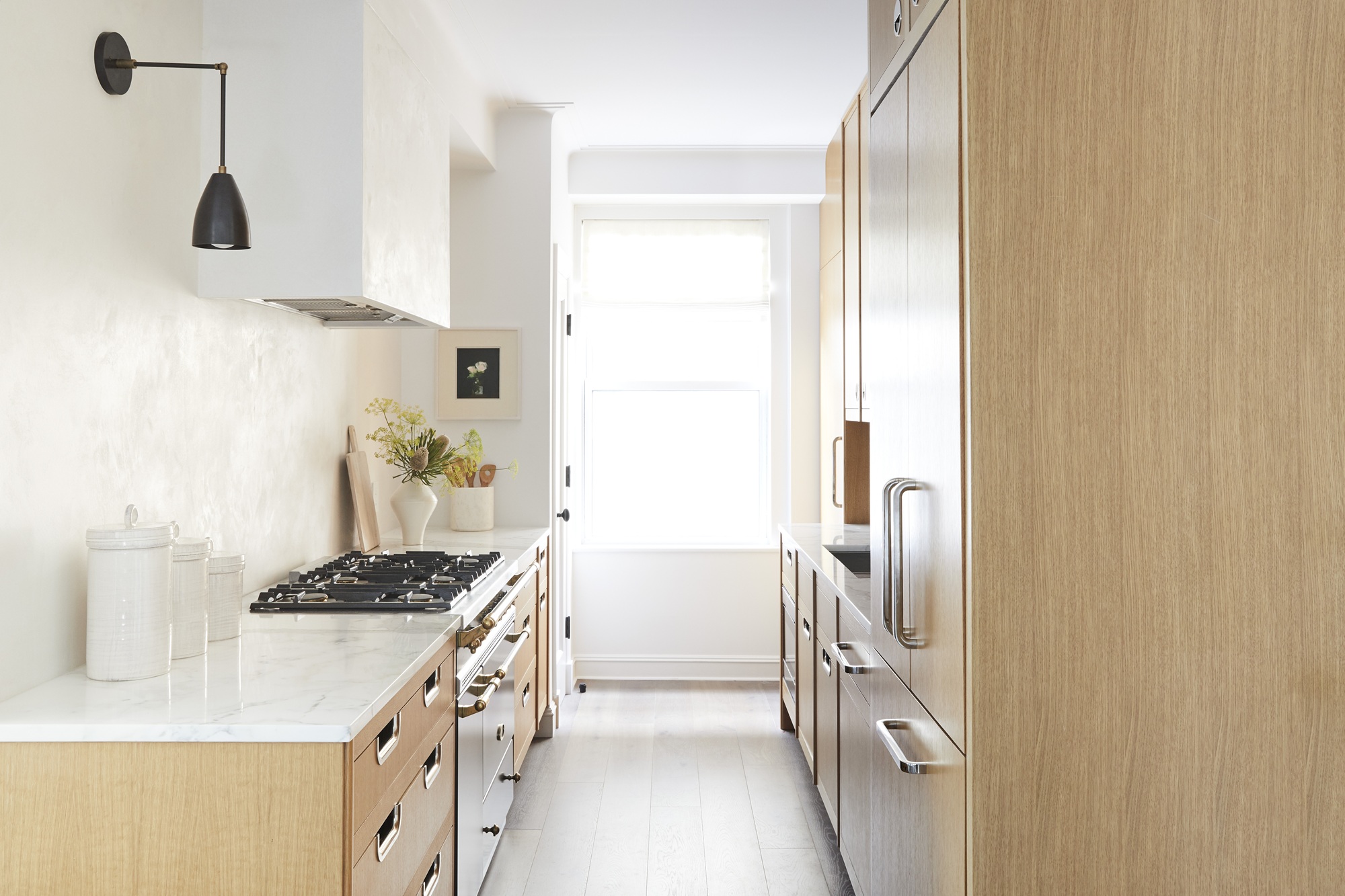 a minimalist kitchen with wood and lime plaster walls