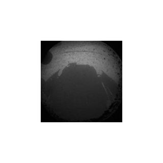 This first image from the Mars rover Curiosity on the surface of Mars shows the rover's shadow as seen by a navigation camera. NASA released the image just minutes after the rover's successful Aug. 5 PDT, 2012 landing.