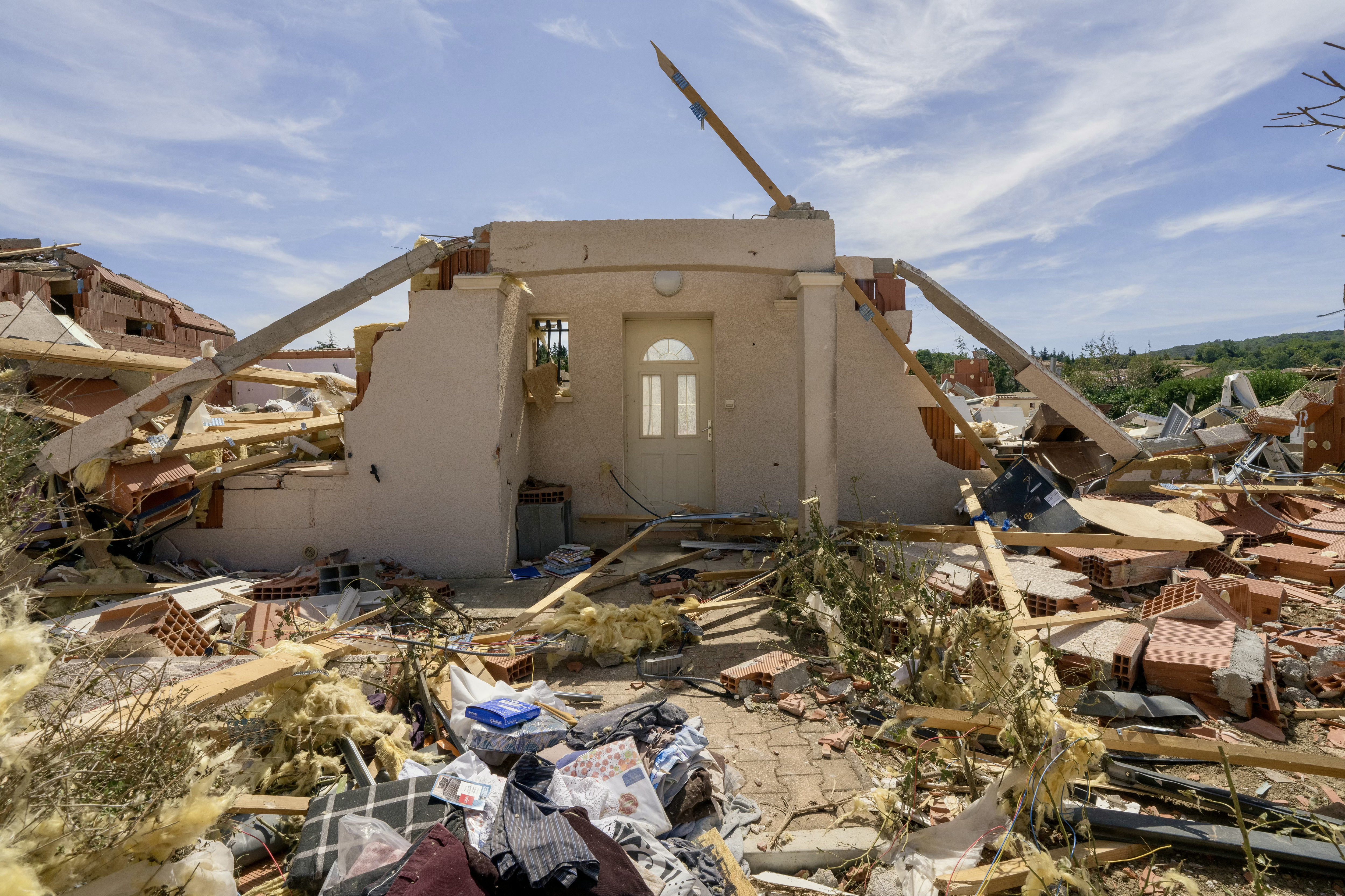 TOPSHOT - This photograph shows a damaged house following a tornado in Pomas, southwestern France on August 25, 2026. A tornado of rare intensity devastated a village in southern France, causing widespread destruction and leaving residents in shock on August 25, 2026, with the mayor describing the aftermath as resembling "wartime". The tornado, which swept through the Aude department late Monday afternoon, hit the small village of Pomas hardest, bringing down walls, tearing off roofs, and uprooting trees. (Photo by Idriss Bigou-Gilles / AFP via Getty Images)