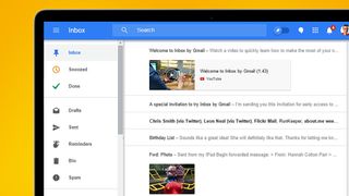 A laptop on an orange background showing Inbox by Gmail