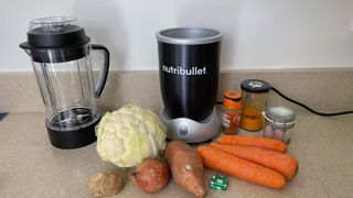 Nutribullet Rx with ingredients for a soup (cauliflower, carrot, sweet potato and stock)
